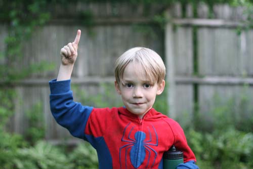 Boy pointing up with his index finger