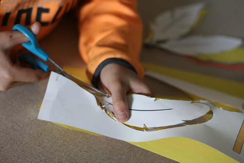 Boy cutting out feather