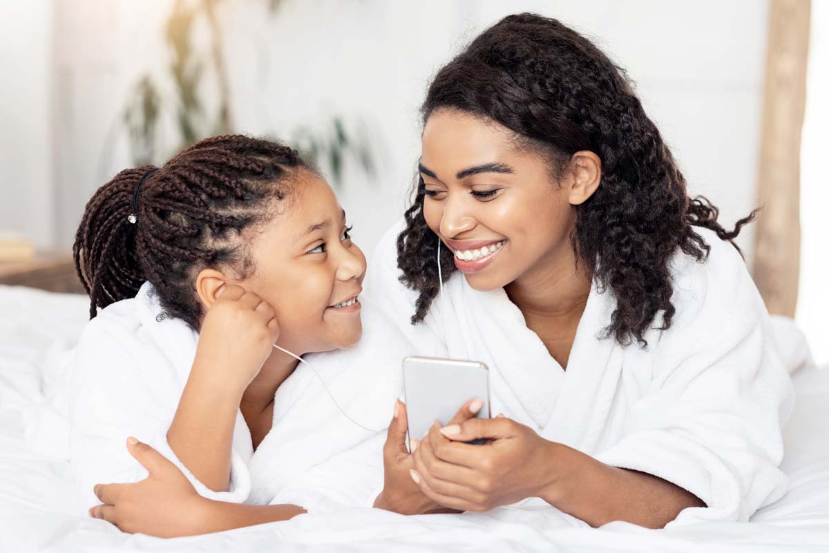 mother and daughter listening to music together